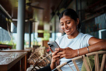 Young Woman Engaged with Smartphone in Modern Caf Setting
