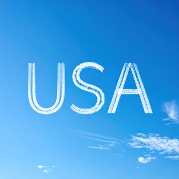 Usa skywriting on clear blue sky with wispy clouds