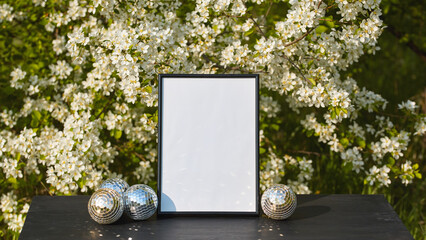 Elegant mockup with blank frame surrounded by spring flowers for holiday greetings © Marina Shvetsova