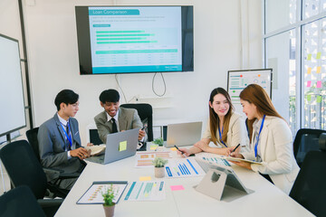 Diverse Modern Office: Motivated Businessman Leads Business Meeting with Managers, Talks, uses Presentation TV with Statistics, Chart Growth, Big Data. Digital Entrepreneurs Work on e-Commerce Project