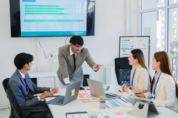 .Group of Asian business people collaborate during team meeting in high quality modern office.