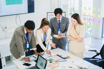 Asian business people chatting amicably during a meeting.