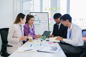 Business team woman and man asian group meeting sitting on desk looking talk think creative idea computer on table ready happy working new project job online product sale marketing in office company.