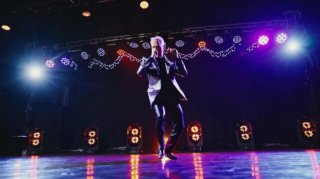 Energetic singer dancing on stage during music concert