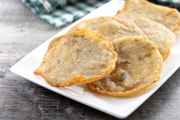 Tortillitas de camarones on wooden table. Traditional spanish food.