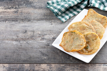 Tortillitas de camarones on wooden table. Traditional spanish food. Copy space