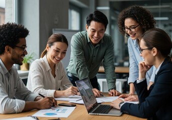 Diverse group of business people collaborating on a project at a table with a laptop