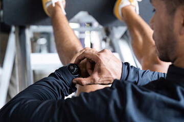 Fitness Tracking. Individual checking smart watch during a workout session.