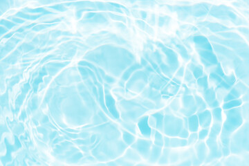 Blue water with ripples on the surface. Defocus blurred transparent blue colored clear calm water surface texture with splashes and bubbles. Water waves with shining pattern texture background.