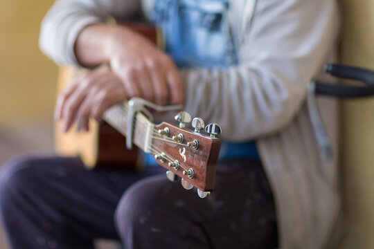 Guitar resting on man's knee