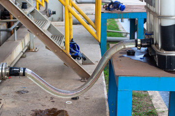 chemical caustic dispensed from IBC tank by hose connection, showing potential leak at valve....