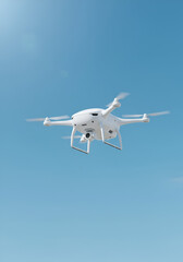 Obraz premium White Drone Soaring Against a Clear Sky