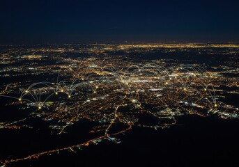 City lights at night show interconnected network across the urban landscape from above