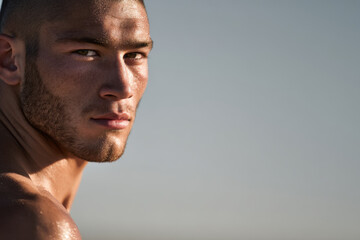 portrait of stuntman with determined expression positioned on left side of frame