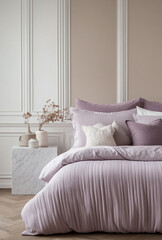 The bed with light purple striped linens, surrounded by white walls and bedside tables the floor is lined with herringbone. The background is a gray wall with paintings. There are plants in the room