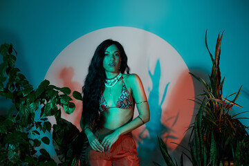 Breezy summer vibes with a beautiful woman in vibrant fashion surrounded by lush greenery