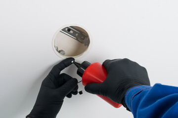 When installing lighting, the master's hands use glue.