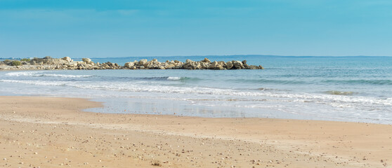 Ocean Waves Gently Kiss Sandy Shoreline.