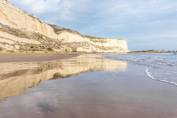 Ocean Waves Gently Kiss Sandy Shoreline.