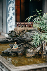 Miniature figure of a man in the Temple of literature in Hanoi, Vietnam