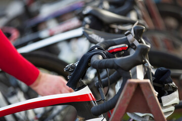 Road bikes on a rack with cyclist in background