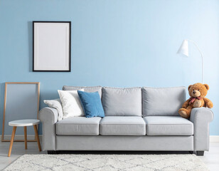 Front view of living room with 3 person sofa and teddy bear on soft blue background.
