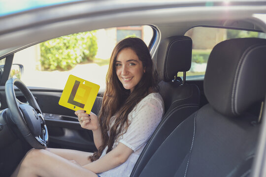 Teenage girl holding L plate