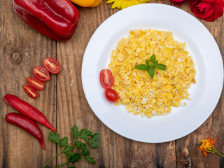 fresh scrambled eggs on white plate on breakfast table