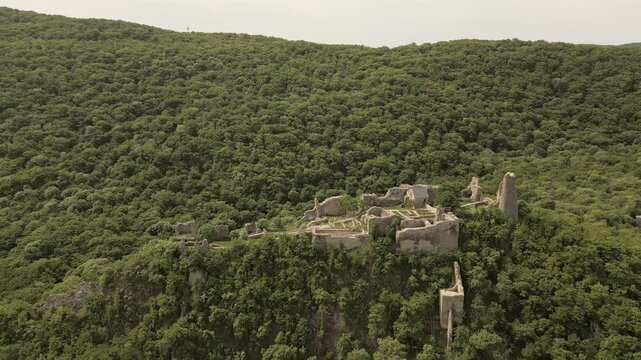 Aerial side view Ujarma Fortress. Ancient Hilltop Royal Citadel and Strategic Stronghold of the Iberian Kings in Kakheti, Georgia. Sightseeing destination in Kakheti wine region