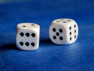Close-Up of Classic White Dice on Blue Surface