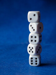 Stack of Five White Dice on Blue Background