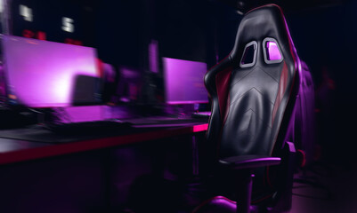 Empty professional gaming setup with neon lights in dark room