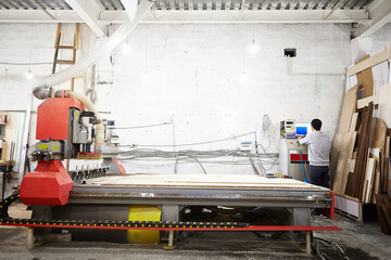 Cnc machine at carpentry workshop. Cutting wood with various router bits.