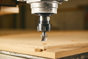 Close-up shot of machine with numerical control cuts wood. Cnc tool.