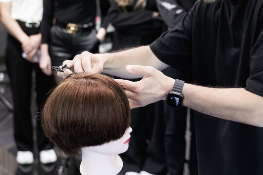 Hairstyling and barber education course in progress with students learning professional haircut techniques step by step
