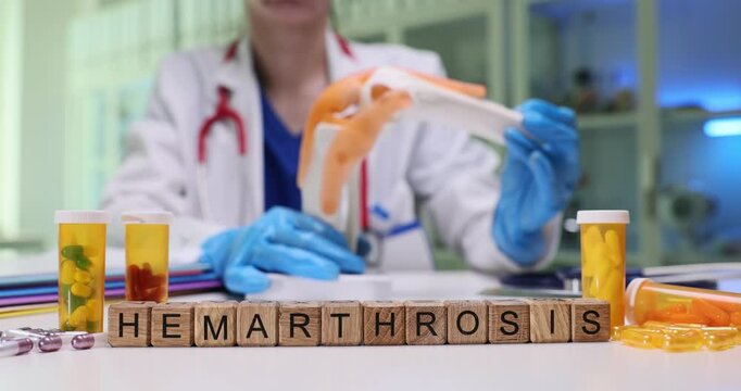 A skilled medical practitioner demonstrates hemarthrosis using a combination of visual aids and laboratory specimens