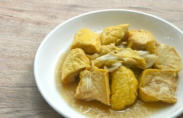 fried cabbage with slice soft yellow tofu vegetarian food on plate