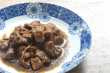 salty boiled slice dice pork meat in soy sauce on plate