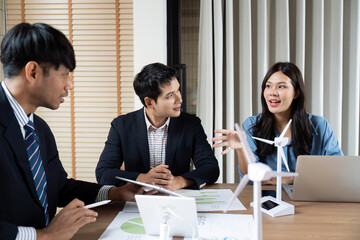 Sustainability and ESG. Diverse team collaborating on renewable energy projects in a bright office.