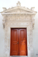 Orange wooden door with decorative stucco of Krasiczyn castle in Poland