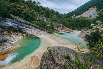 Wild swimming paradise with crystal clear turquoise water. Natural limestone pools formed by river...