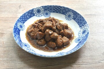 salty boiled slice dice pork meat in soy sauce on plate