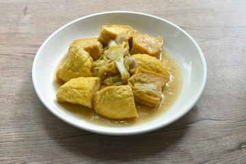 fried cabbage with slice soft yellow tofu vegetarian food on plate