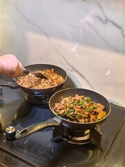 Cooking Delicious Stir-Fry with Meat and Vegetables in Modern Kitchen on Stovetop