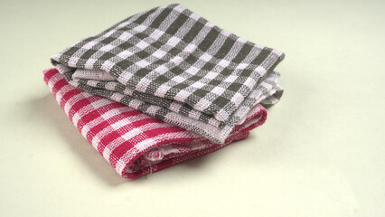 Clean sponge cloths with a checkered pattern isolated on white background. Household cleaning...