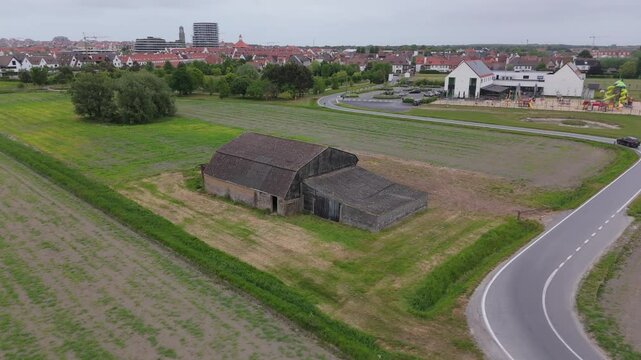 Orbit Shot Around Rustic Barn in Fields with Knokke in Distance | FlyLens 4K
