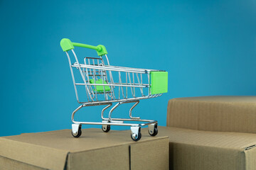 The shopping cart on the concept cardboard box