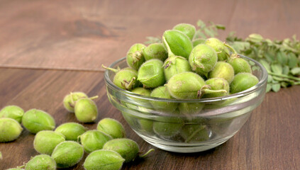 Fresh Green chickpeas on a branch, and in the pod, isolated on wooden background.