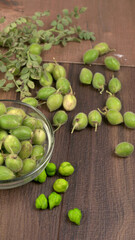 Fresh Green chickpeas on a branch, and in the pod, isolated on wooden background.