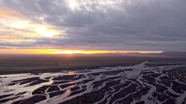 Aerial drone view of braided river, during midnight sunset in summer, Iceland